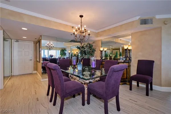 a view of a dining room with furniture and chandelier