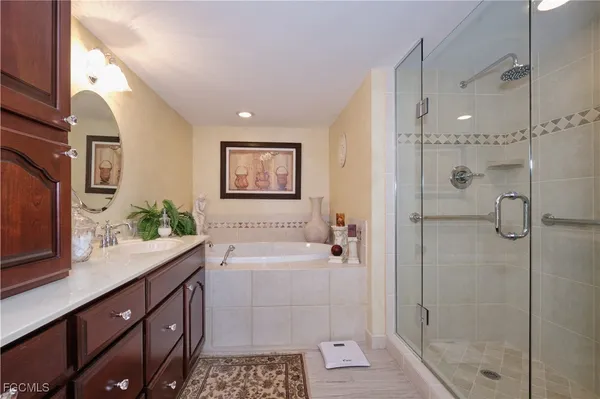 a bathroom with a tub sink and mirror