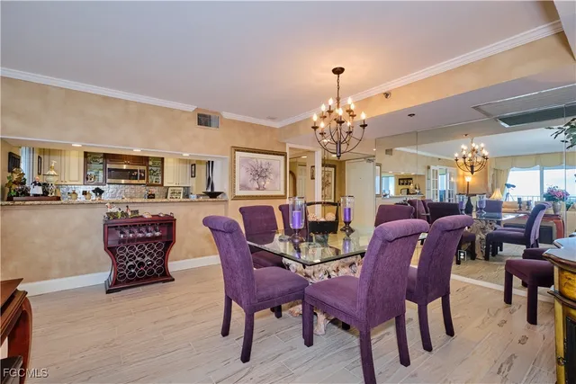 a view of a dining room with furniture and chandelier