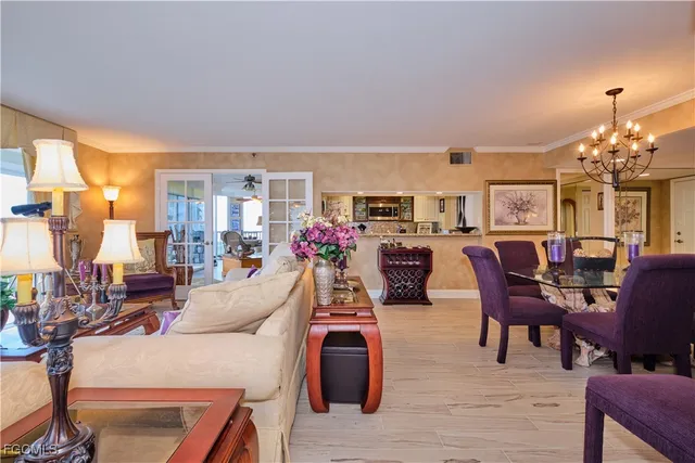 a living room with furniture a dining table and chairs with wooden floor