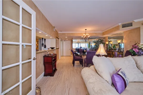a living room with lots of furniture and a large window