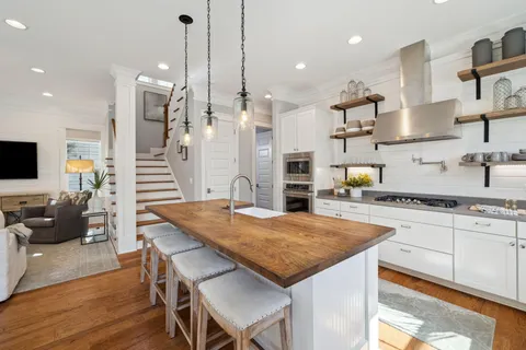 a view of a dining room with furniture wooden floor and chandelier
