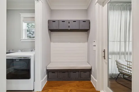 a view of a patio with couches and table and chairs with wooden floor and fence and a ceiling fan