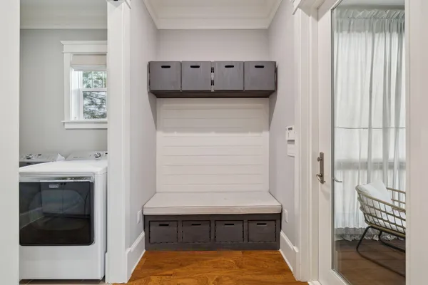 a view of a patio with couches and table and chairs with wooden floor and fence and a ceiling fan