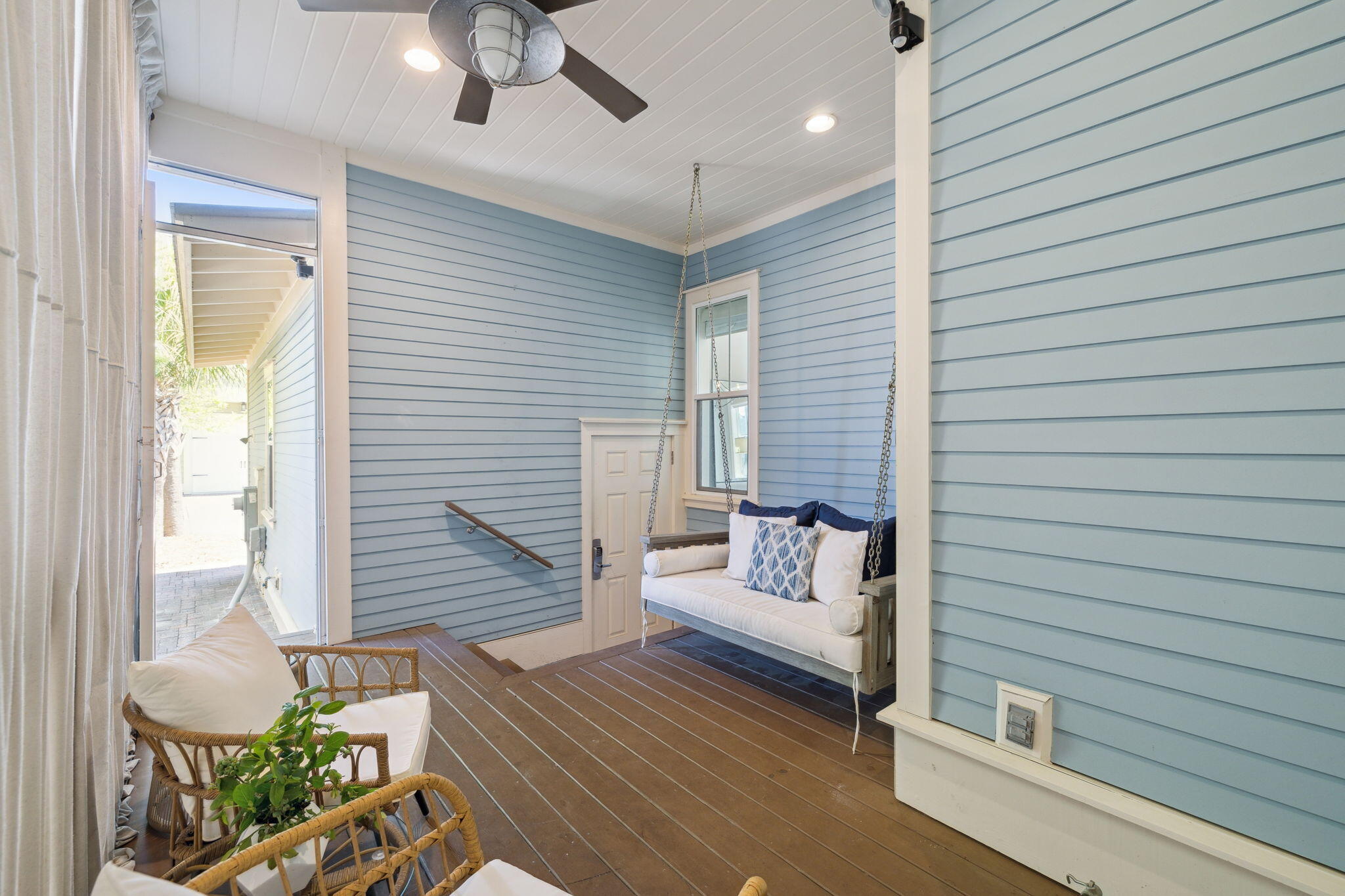 89 Clipper Street Inlet Beach, FL 32461 - Photo 52 of 72 a view of a patio with couches and table and chairs with wooden floor and fence and a ceiling fan