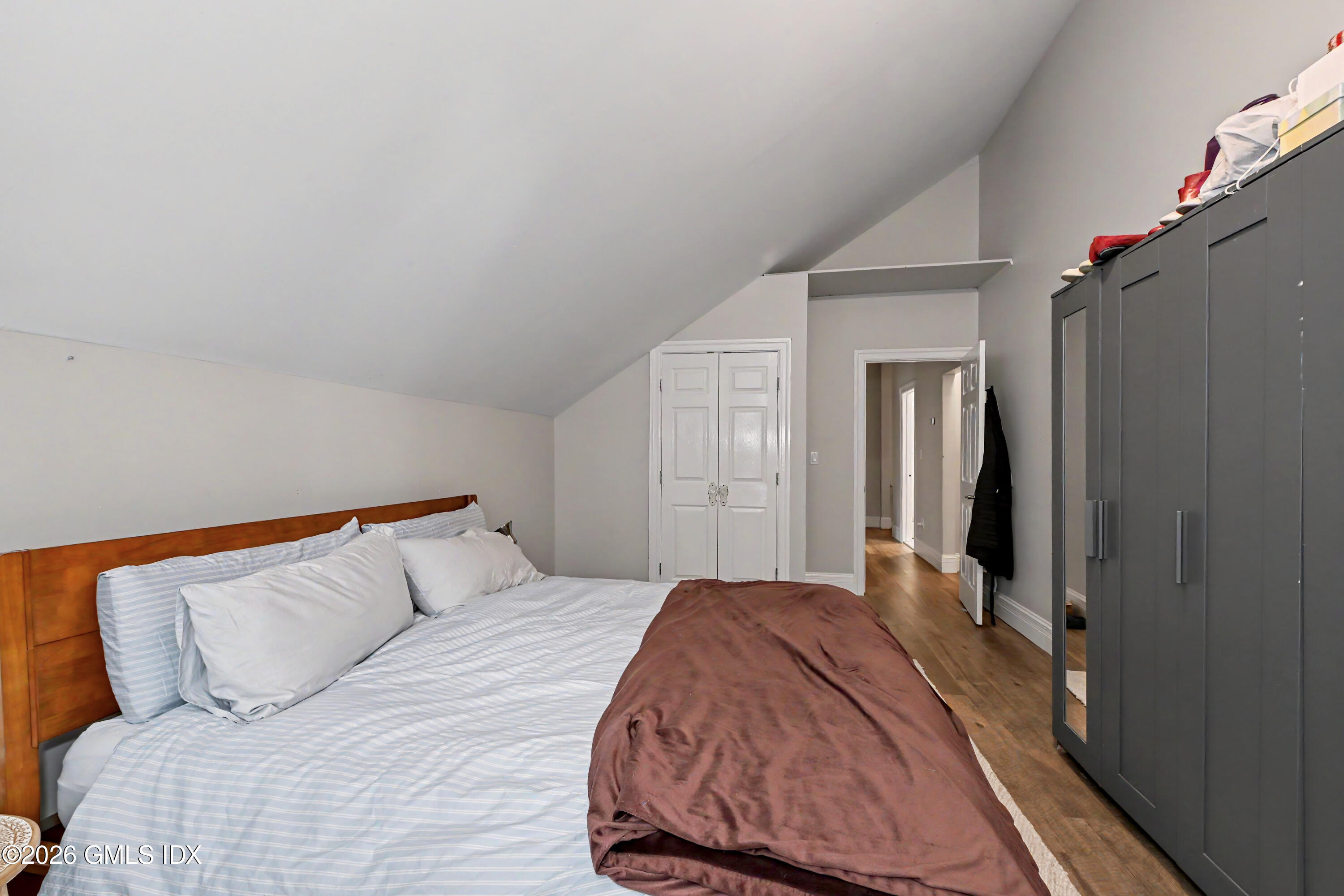 37 Prospect Street Greenwich, CT 06830 - Photo 27 of 41 a bedroom with a large bed and a chandelier