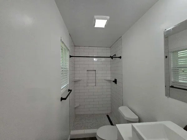 a bathroom with a toilet and a shower