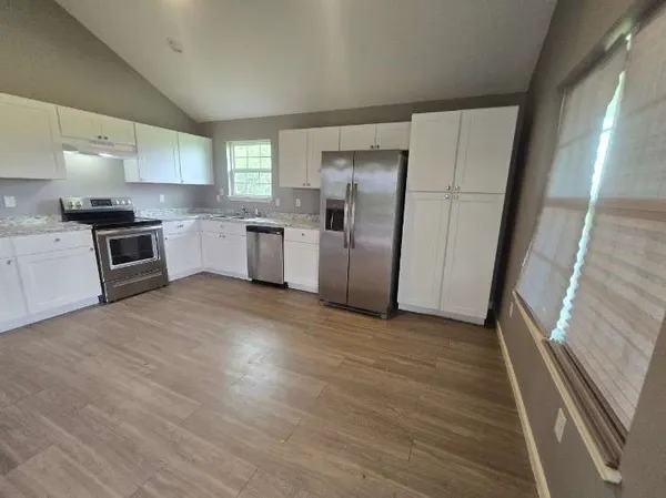 a kitchen with a refrigerator a sink a stove a microwave and island