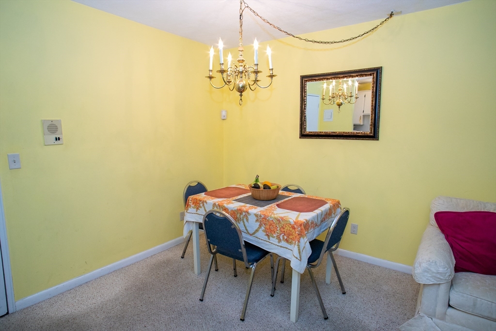 110 Boston Post Road East, Unit 104 Marlborough, MA 01752 - Photo 11 of 28 a view of a dining room with a table and chairs
