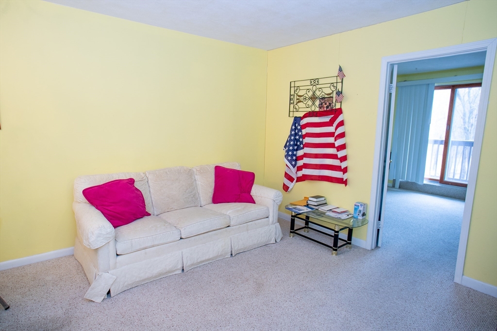 110 Boston Post Road East, Unit 104 Marlborough, MA 01752 - Photo 13 of 28 a living room with furniture and a couch