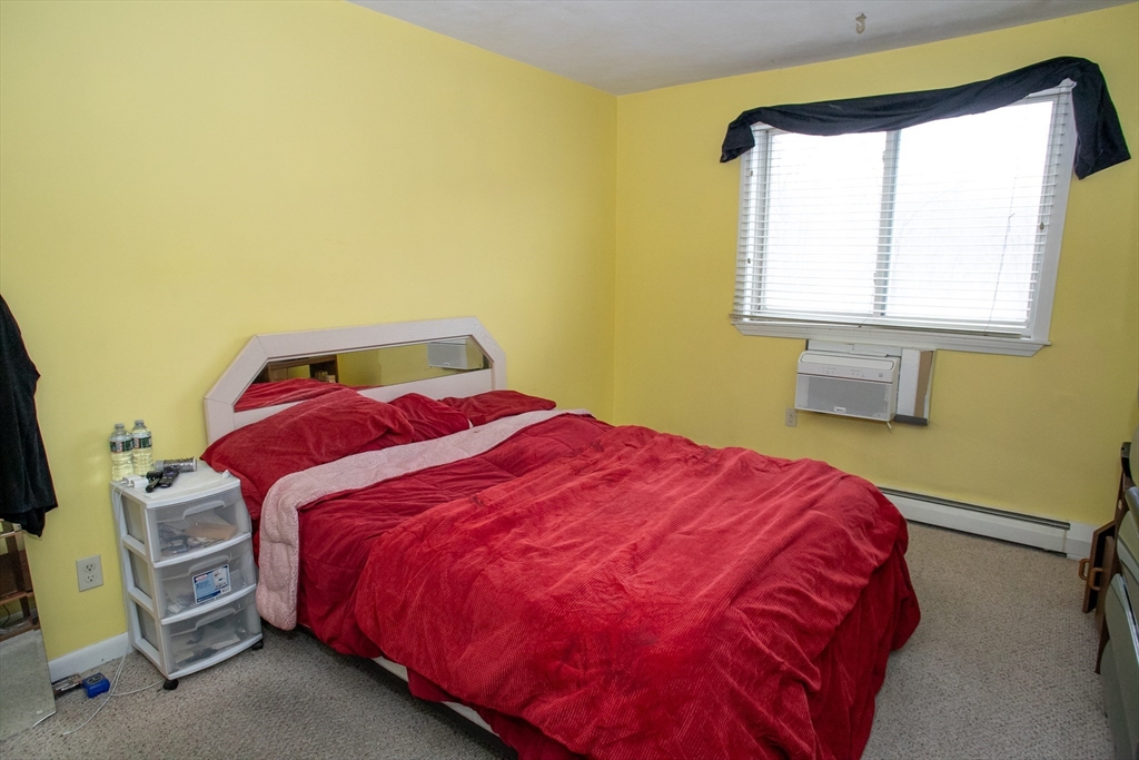 110 Boston Post Road East, Unit 104 Marlborough, MA 01752 - Photo 23 of 28 a bedroom with a bed and a window