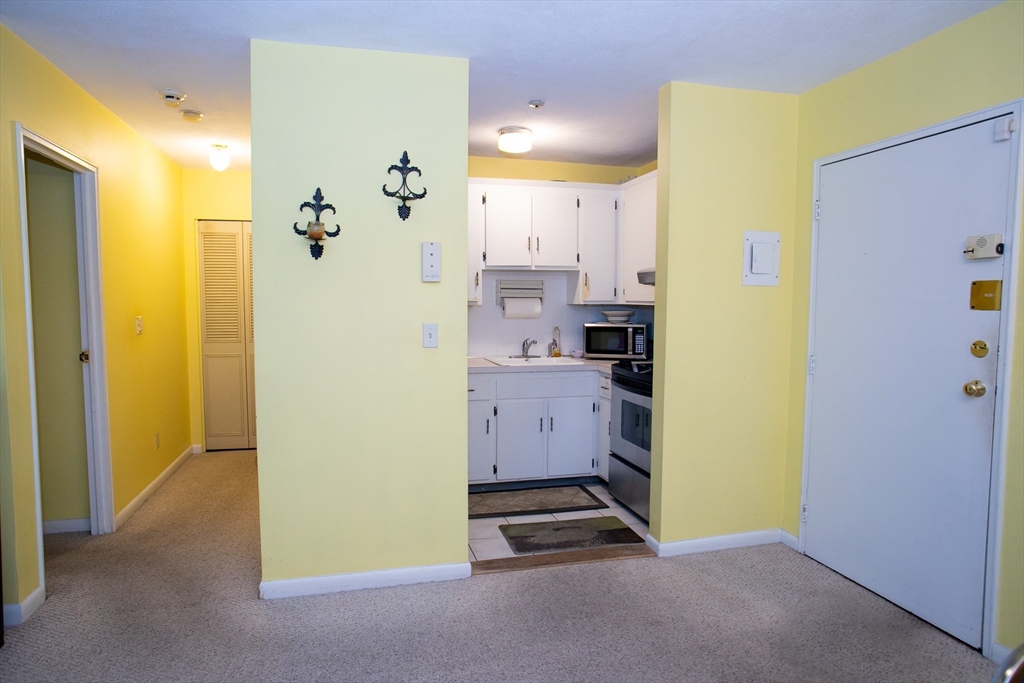 110 Boston Post Road East, Unit 104 Marlborough, MA 01752 - Photo 24 of 28 a view of kitchen center with refrigerator and white wall