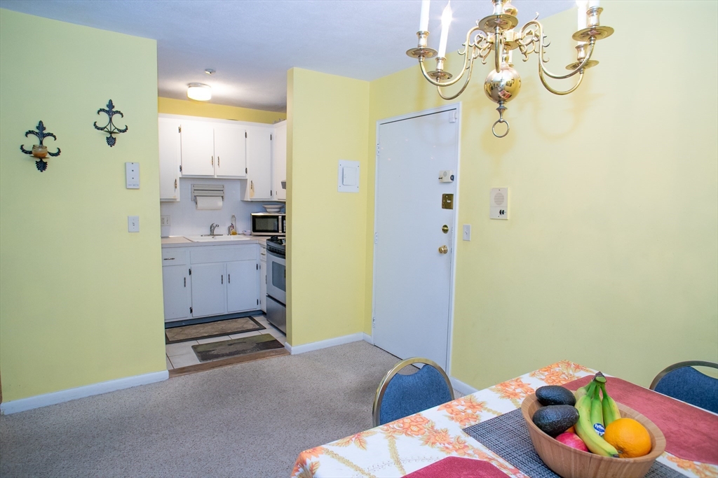 110 Boston Post Road East, Unit 104 Marlborough, MA 01752 - Photo 5 of 28 a bedroom with a bed and ceiling fan