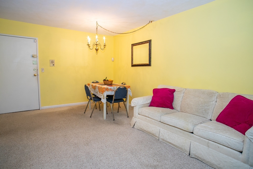 110 Boston Post Road East, Unit 104 Marlborough, MA 01752 - Photo 10 of 28 a living room with furniture and a table
