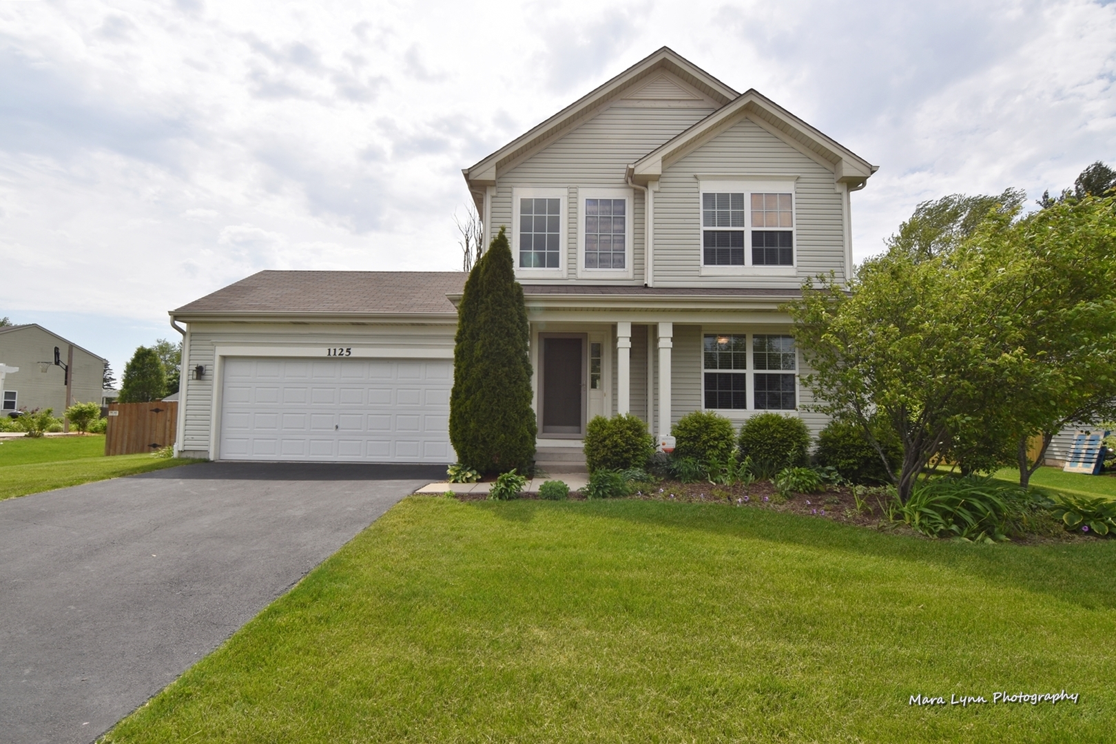 1125 Bailey Road Sycamore, IL 60178 - Photo 1 of 30 a front view of a house with a yard and garage