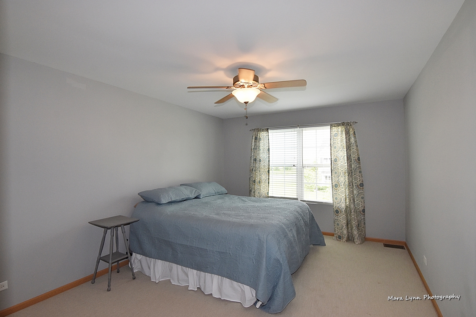 1125 Bailey Road Sycamore, IL 60178 - Photo 14 of 30 a bedroom with a bed and a chandelier