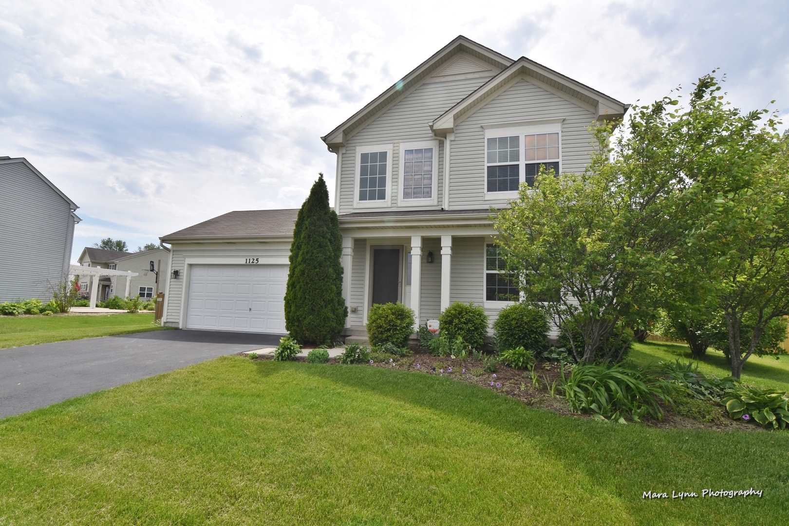 1125 Bailey Road Sycamore, IL 60178 - Photo 30 of 30 a front view of a house with a yard and garage