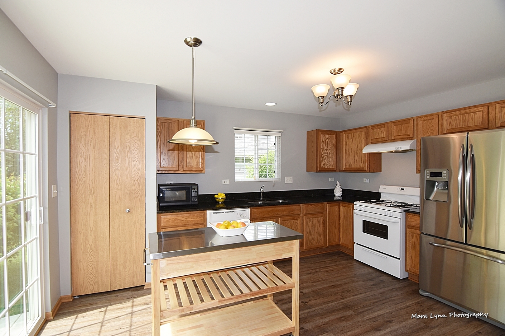 1125 Bailey Road Sycamore, IL 60178 - Photo 9 of 30 a kitchen with stainless steel appliances granite countertop a sink refrigerator and cabinets