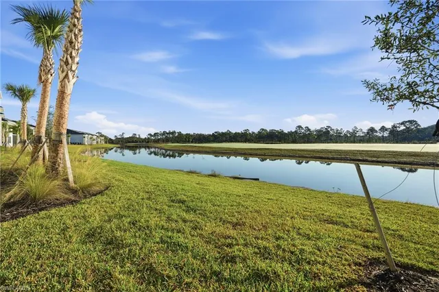 a view of a lake with houses in the back