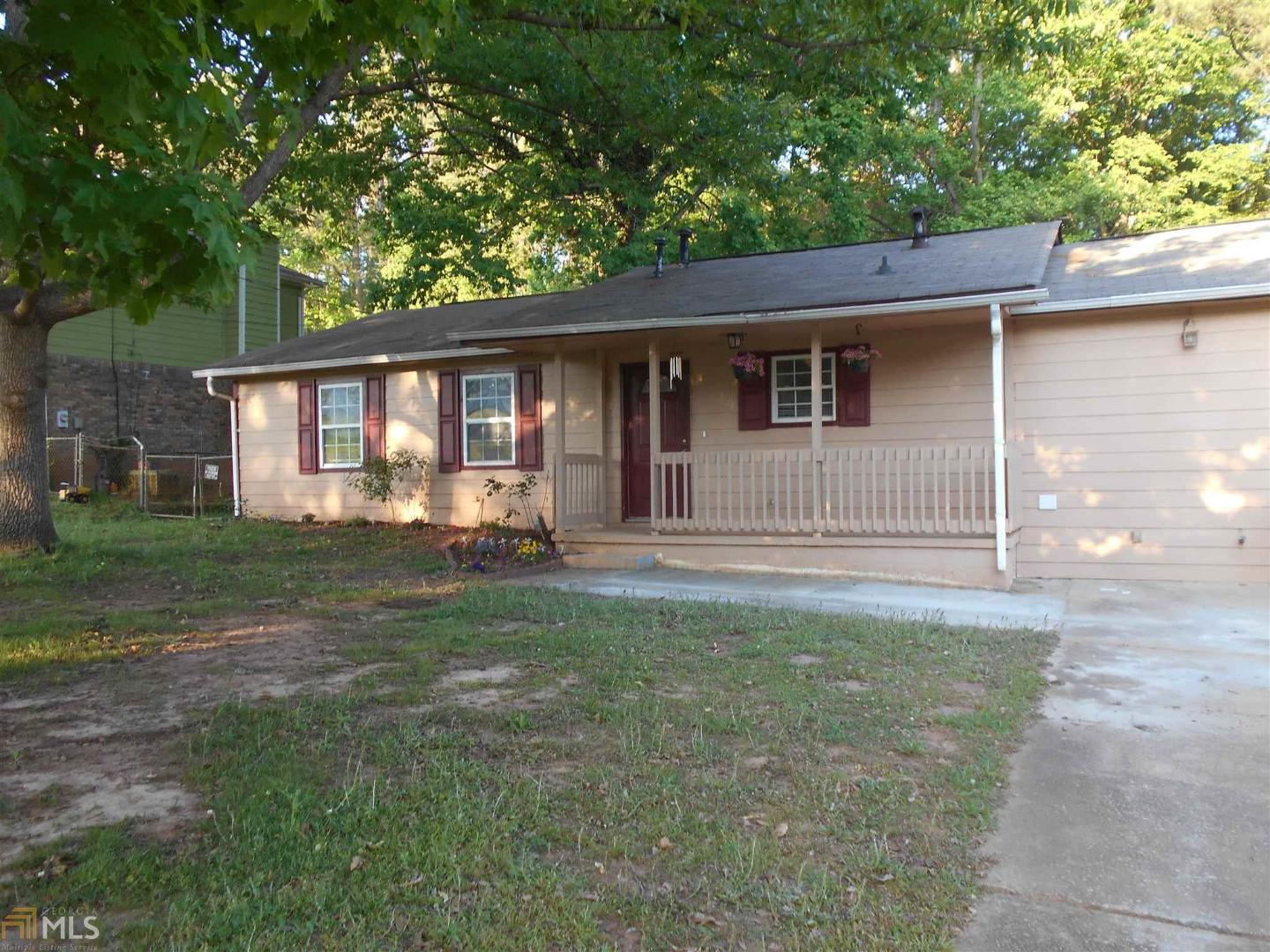 6156 Katherine Road Rex, GA 30273 - Photo 1 of 1 a backyard of a house with potted plants and large tree