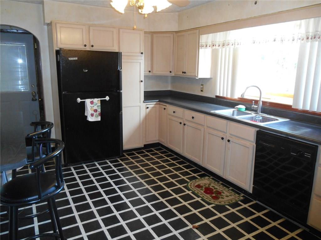 Spacious Kitchen with an abundance of updated cabinets, Dishwasher, Refrigerator and Electric Stove with a bay window.