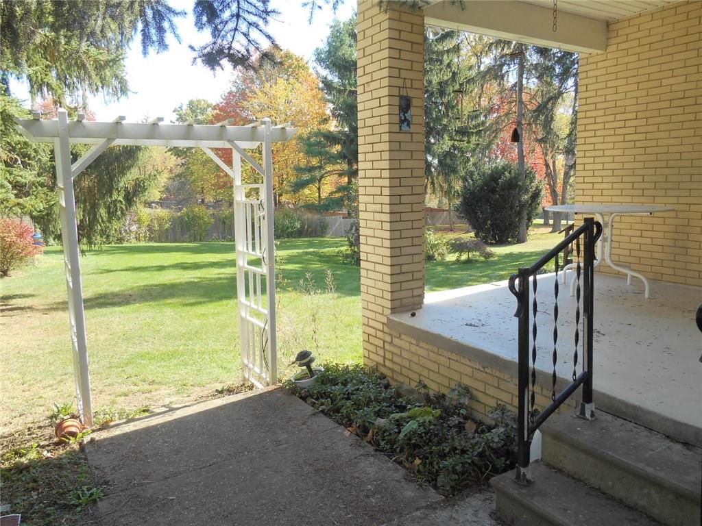 1098 Mercer Road Beaver Falls, PA 15010 - Photo 10 of 18 Side covered porch with trellis leading to back yard.