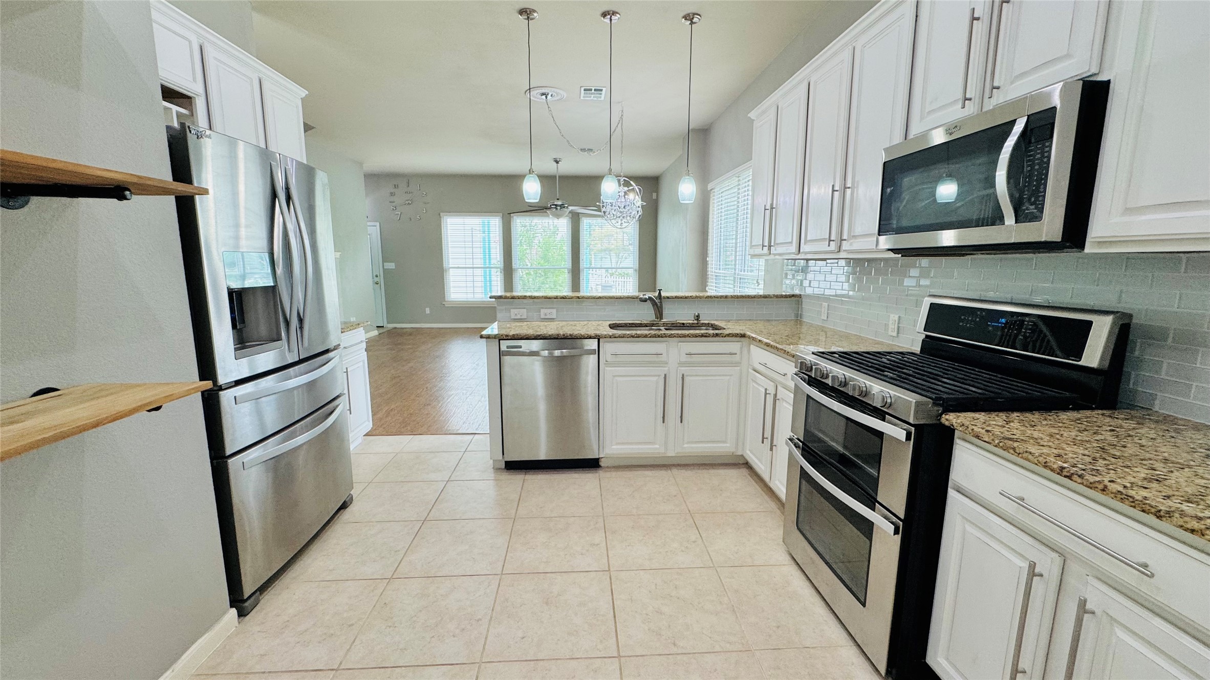 401 Witte Road Kyle, TX 78640 - Photo 7 of 24 Culinary delights await in this bright kitchen with modern stainless steel appliances and ample counter space.