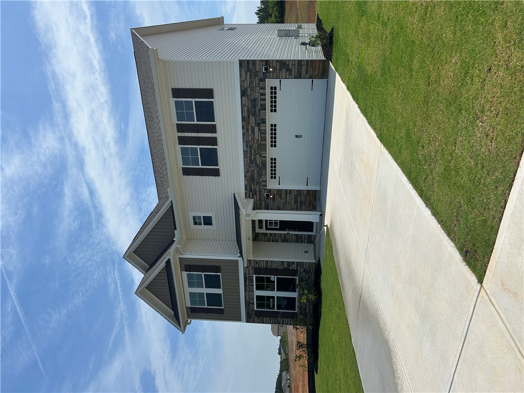 211 Bellflower Lane Anderson, SC 29625 - Photo 3 of 28 A classic facade combining stone and siding with a prominent garage and inviting driveway.