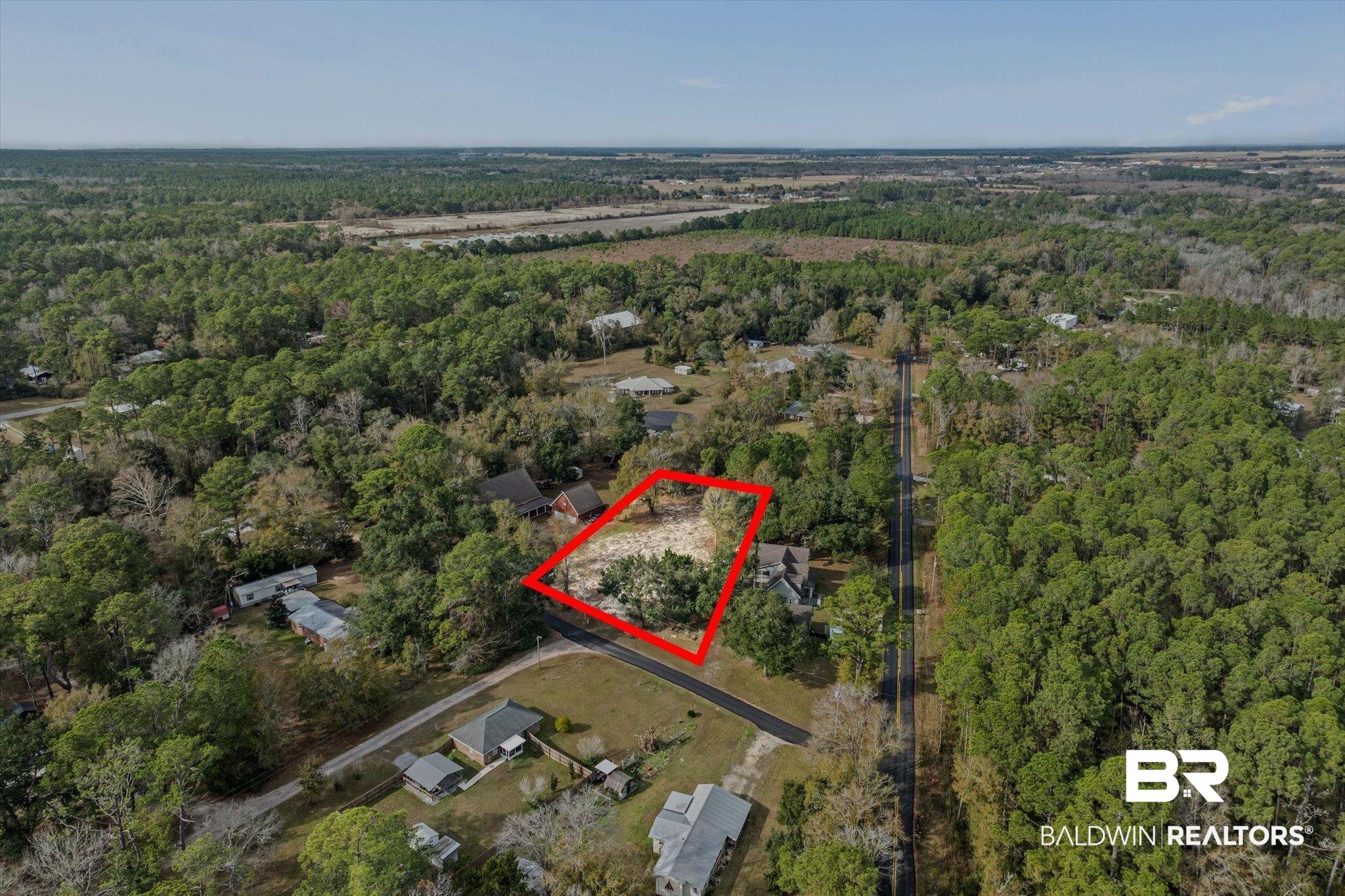 17065 Britt Lane Bon Secour, AL 36511 - Photo 12 of 15 Aerial view of property and surrounding area featuring property boundaries highlighted and a heavily wooded area