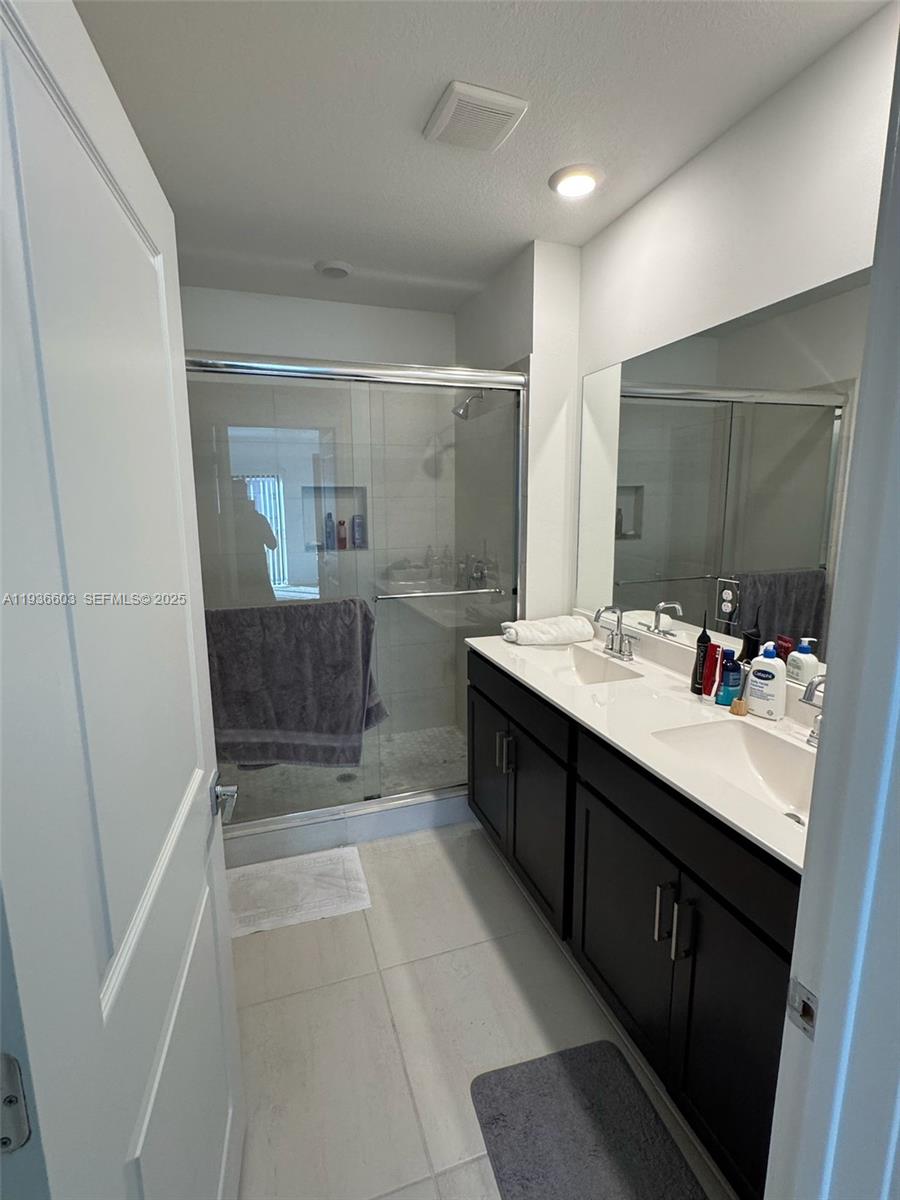 141 Northeast 13th Circle Homestead, FL 33033 - Photo 17 of 19 a spacious bathroom with a mirror a sink and a mirror