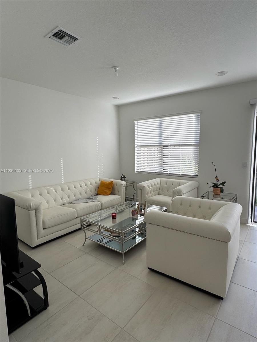 141 Northeast 13th Circle Homestead, FL 33033 - Photo 4 of 19 a living room with furniture and a window