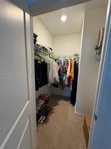 a view of a closet with storage