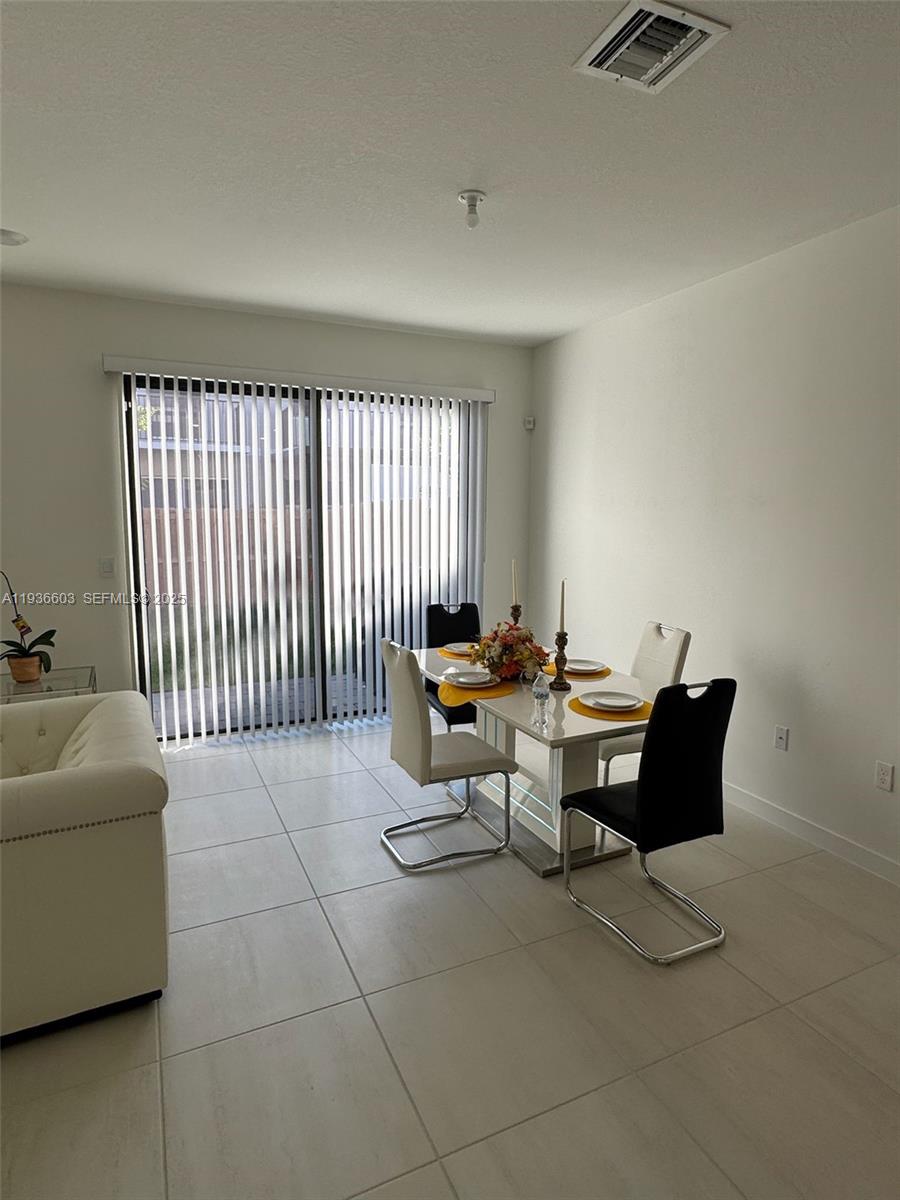 141 Northeast 13th Circle Homestead, FL 33033 - Photo 8 of 19 a living room with furniture and a window