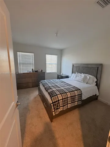 a bedroom with a bed and window