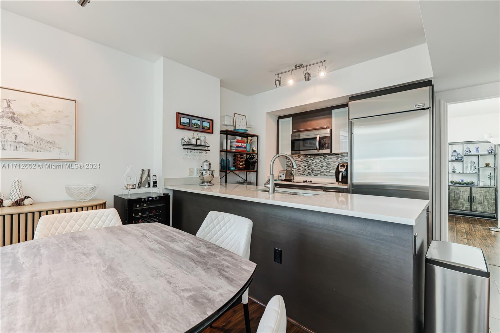 55 Southeast 6th Street, Unit 3407 Miami, FL 33131 - Photo 15 of 33 a kitchen with stainless steel appliances granite countertop a sink and a refrigerator