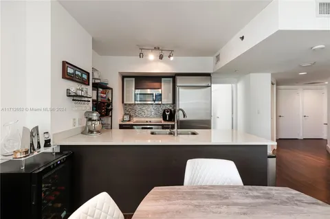 a kitchen with a sink appliances and cabinets