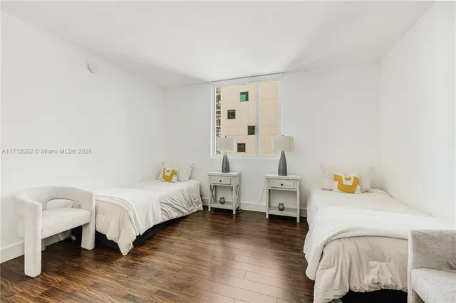 a bedroom with furniture and a wooden floor