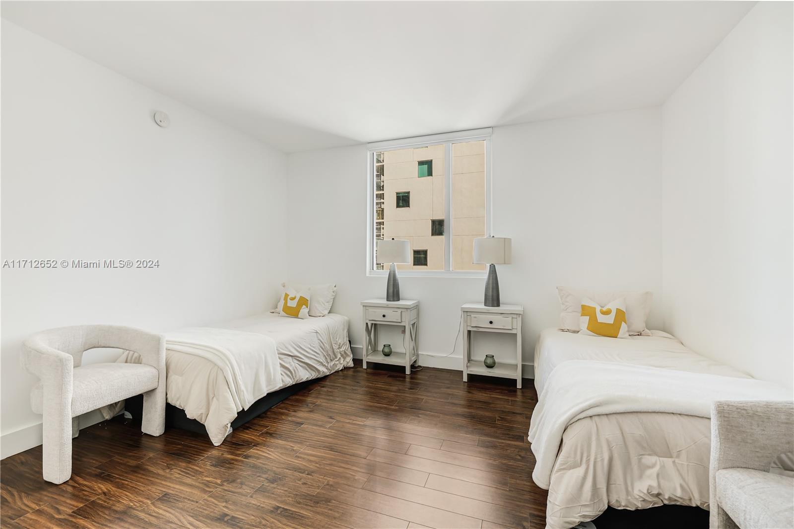 55 Southeast 6th Street, Unit 3407 Miami, FL 33131 - Photo 18 of 33 a bedroom with furniture and a wooden floor