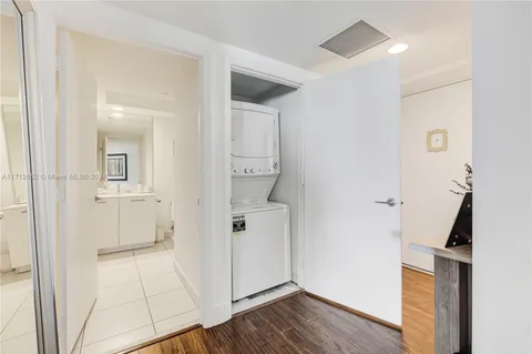 a view of a hallway with closet and wooden floor