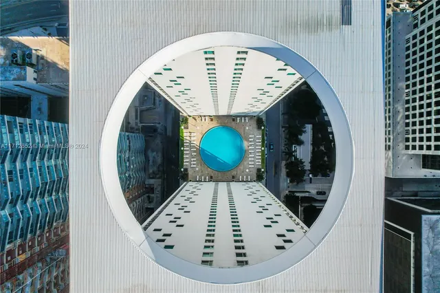 an aerial view of a kitchen with a fireplace and a chandelier