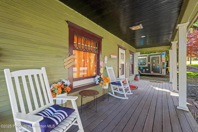 a living room filled with furniture and a floor to ceiling window