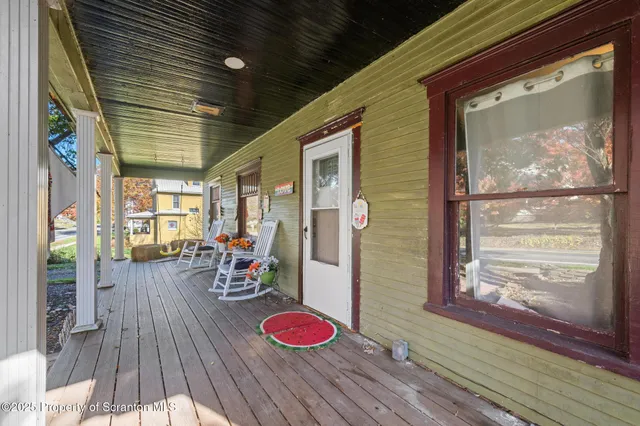 a kitchen with stainless steel appliances granite countertop a refrigerator a stove and a wooden floor