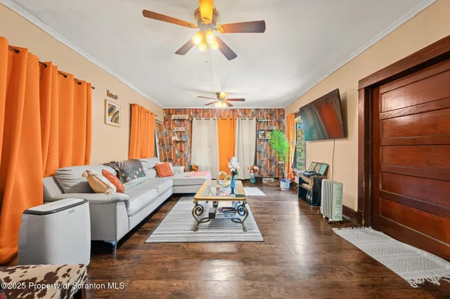 a kitchen with stainless steel appliances granite countertop a refrigerator oven stove a dining table and chairs with wooden floor