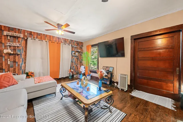 a living room with furniture a rug and a floor to ceiling window