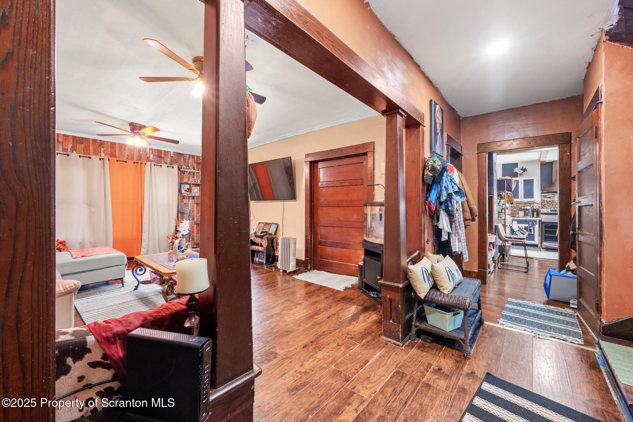 70 State Street Nicholson, PA 18446 - Photo 17 of 64 a living room filled with furniture and a floor to ceiling window