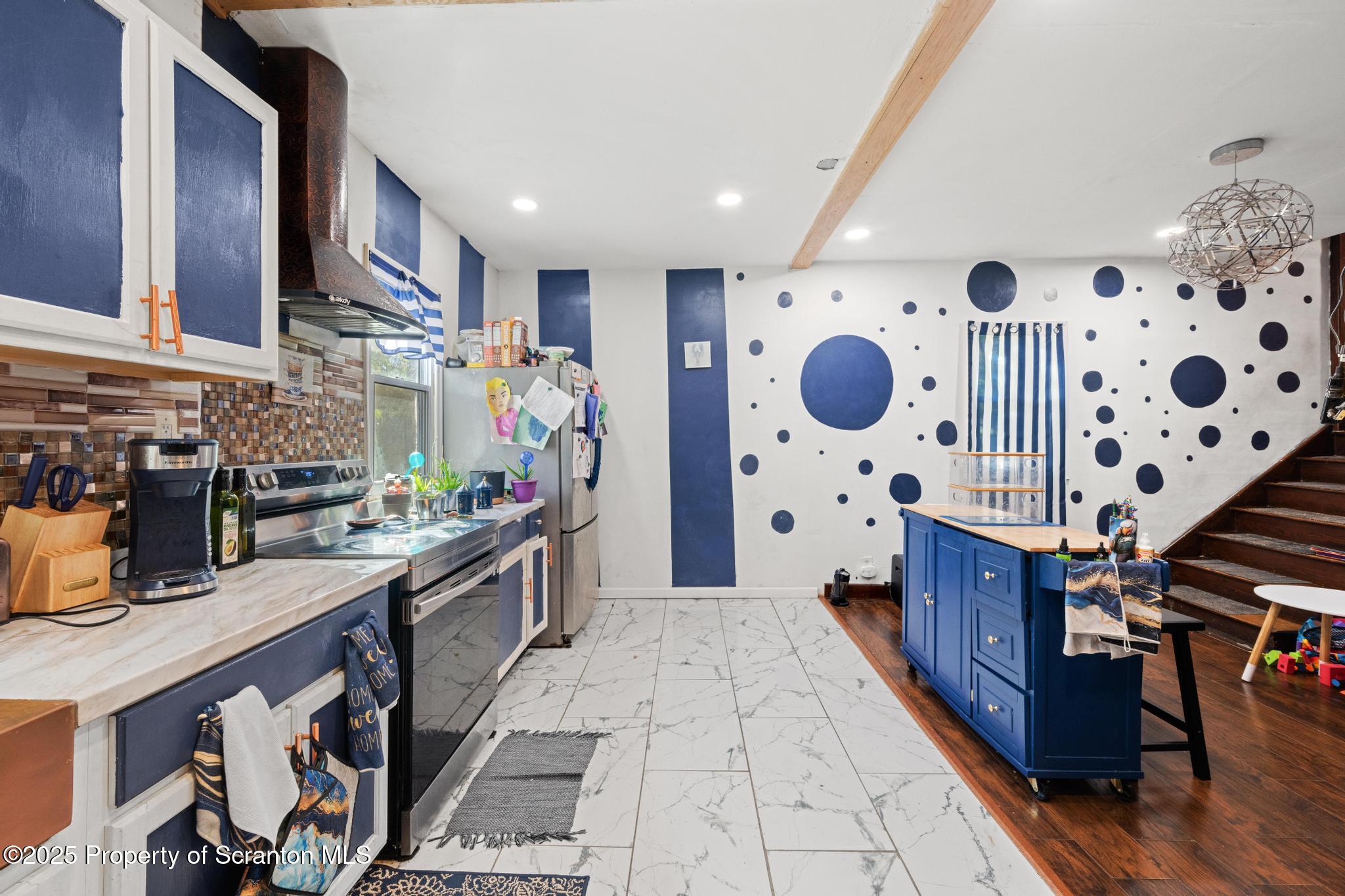 70 State Street Nicholson, PA 18446 - Photo 18 of 64 a kitchen with stainless steel appliances granite countertop a refrigerator a stove and a wooden floor