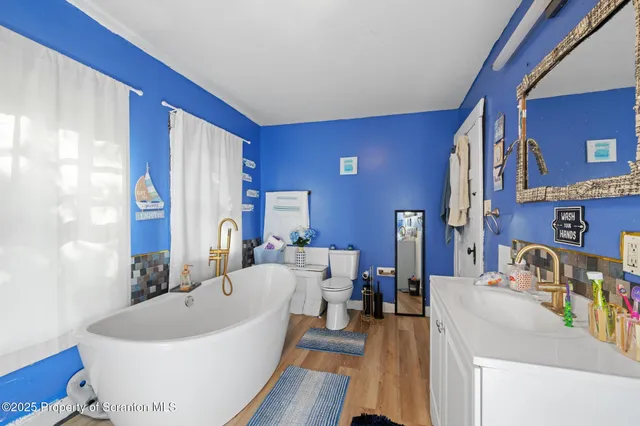 a bed room with bed and paintings on the wall