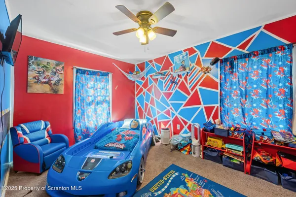 a bed room with a bed and a television