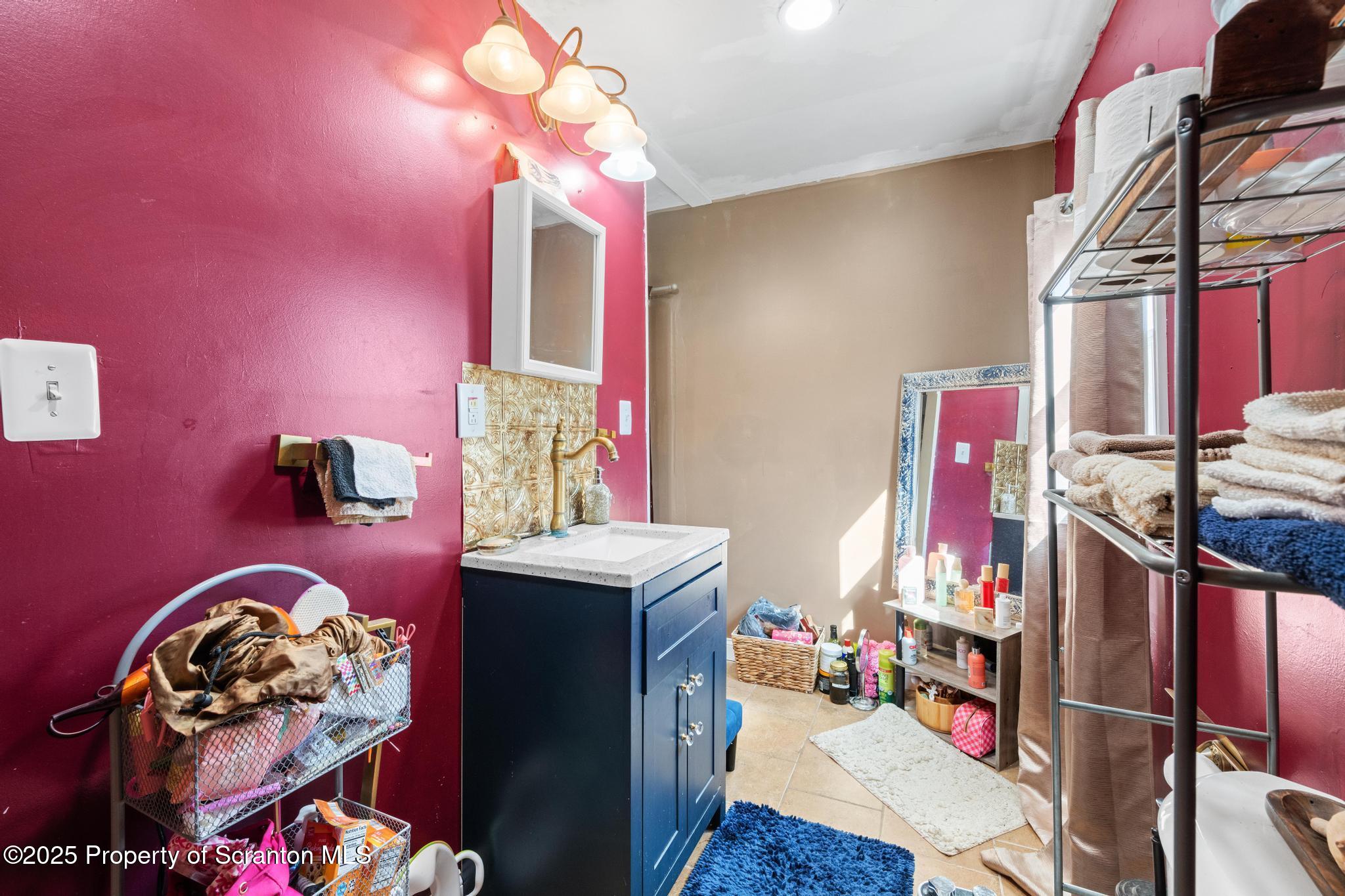 70 State Street Nicholson, PA 18446 - Photo 32 of 64 a bedroom with furniture and a chandelier