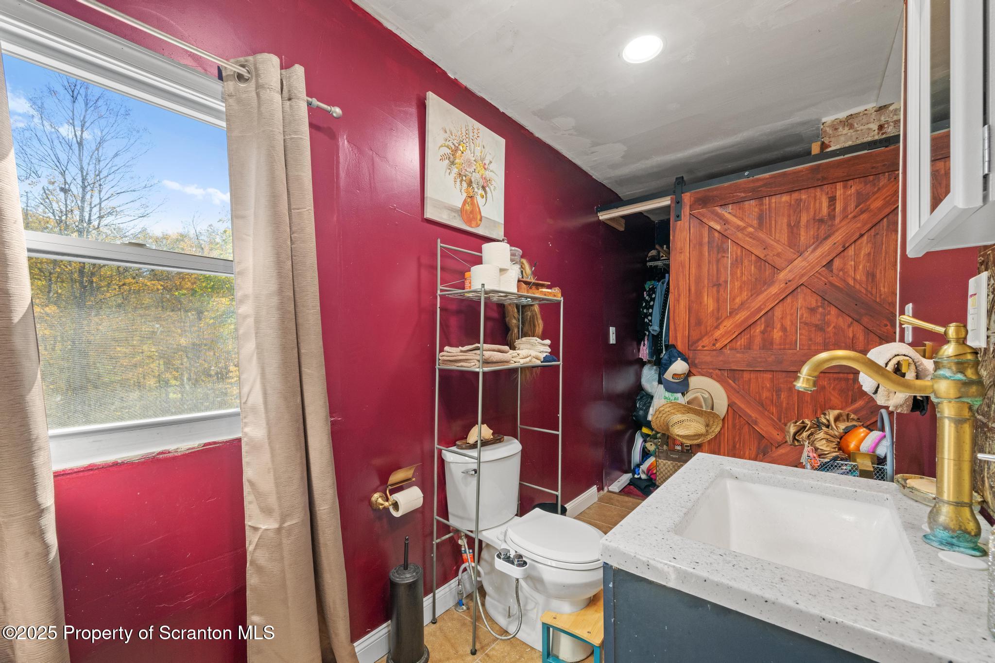 70 State Street Nicholson, PA 18446 - Photo 34 of 64 a bathroom with a sink a toilet and shower curtain